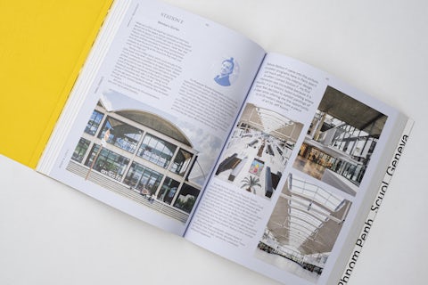 Open book displaying a double-page spread about a modern coworking space interior.