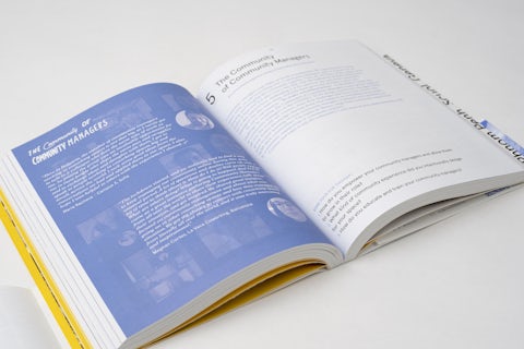 Open book on a spread with images of coworking events and community gatherings.
