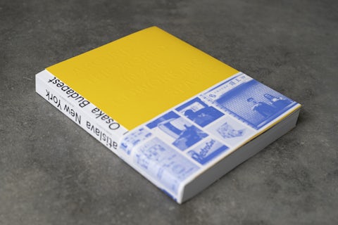 Around the World in 250 Coworking Spaces' book with the blue strip sleave.