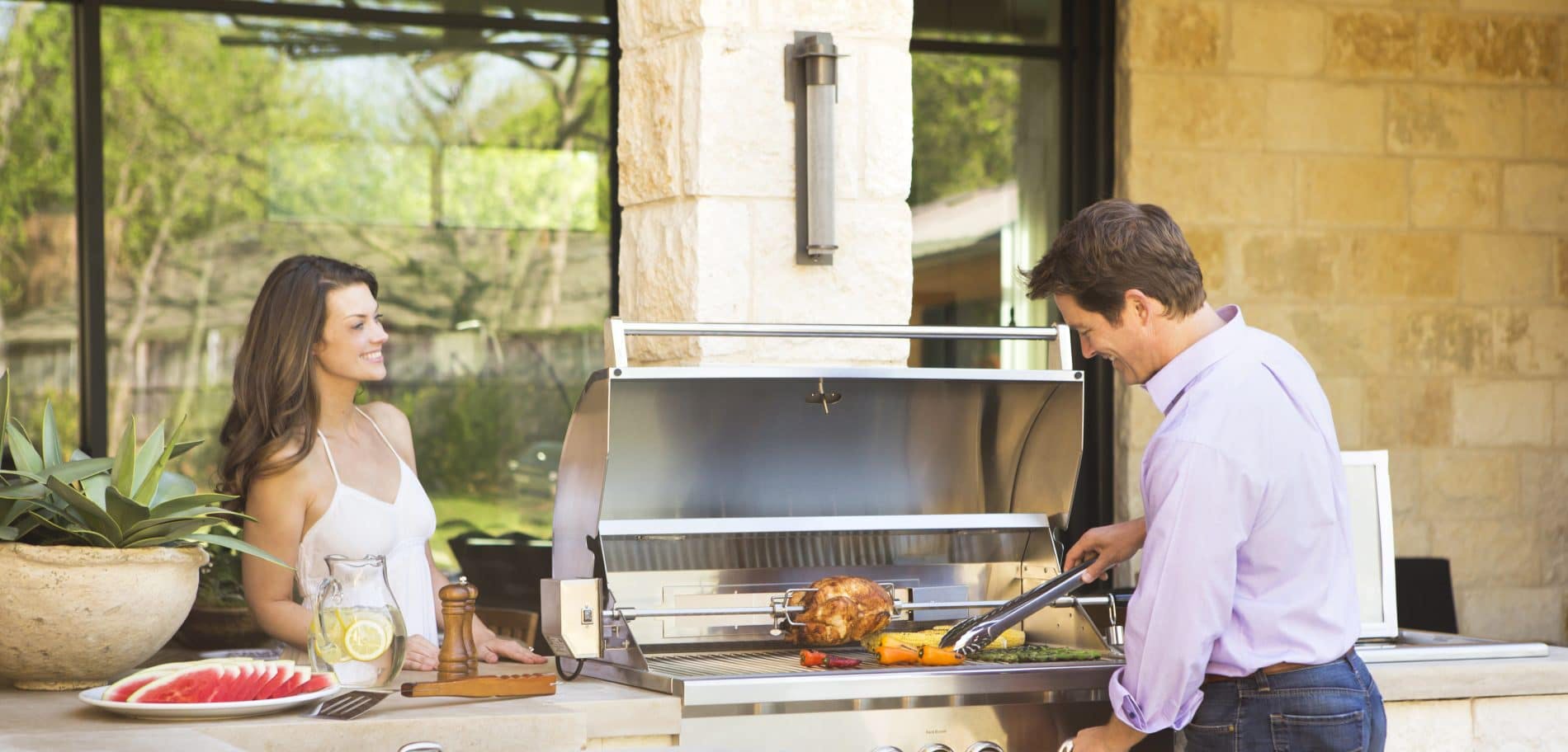 Couple grilling on coyote grill