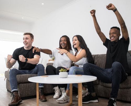 Friends watching the game cheering