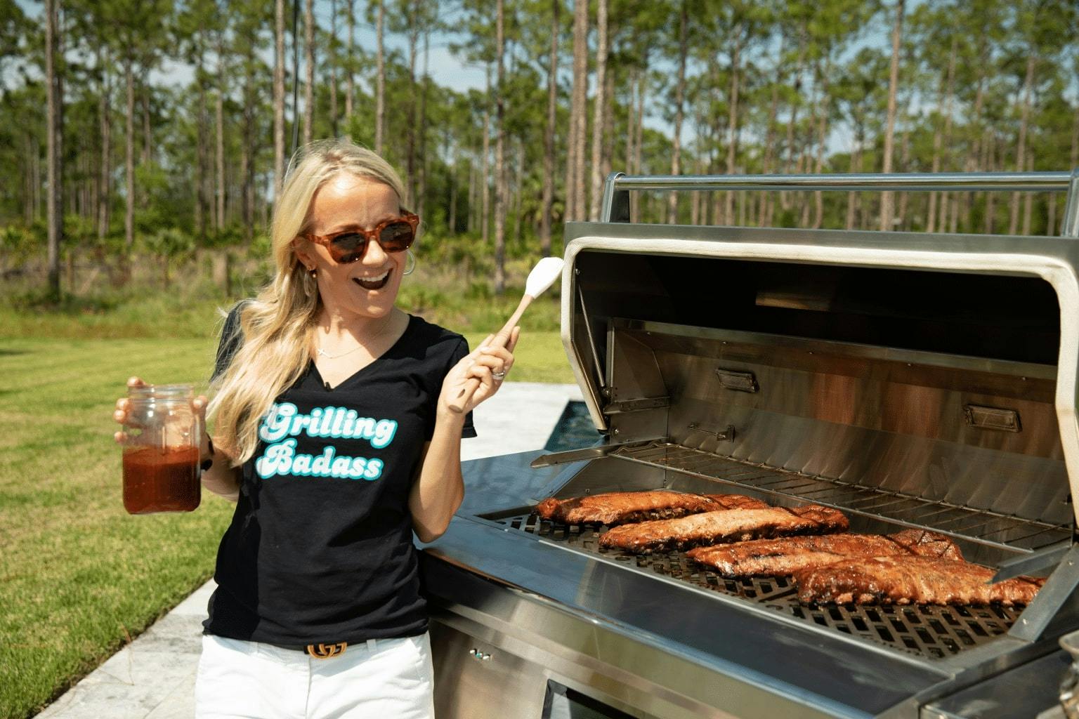 grill girl making ribs on coyote grill