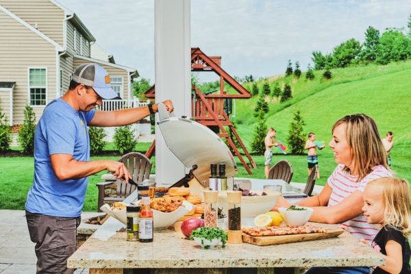 family using coyote grill