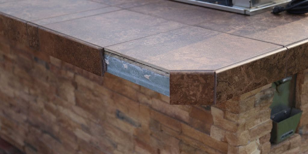Inferior materials used in outdoor kitchen - tiles falling off
