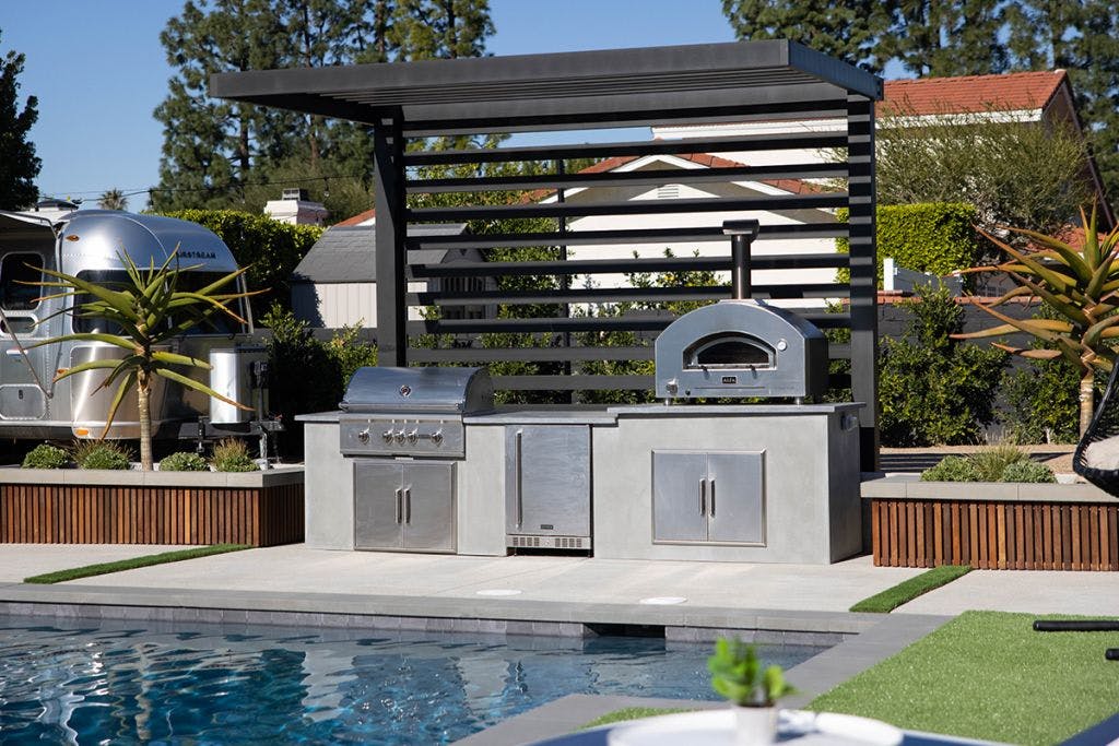 Beautiful poolside custom outdoor kitchen by Coyote Outdoor