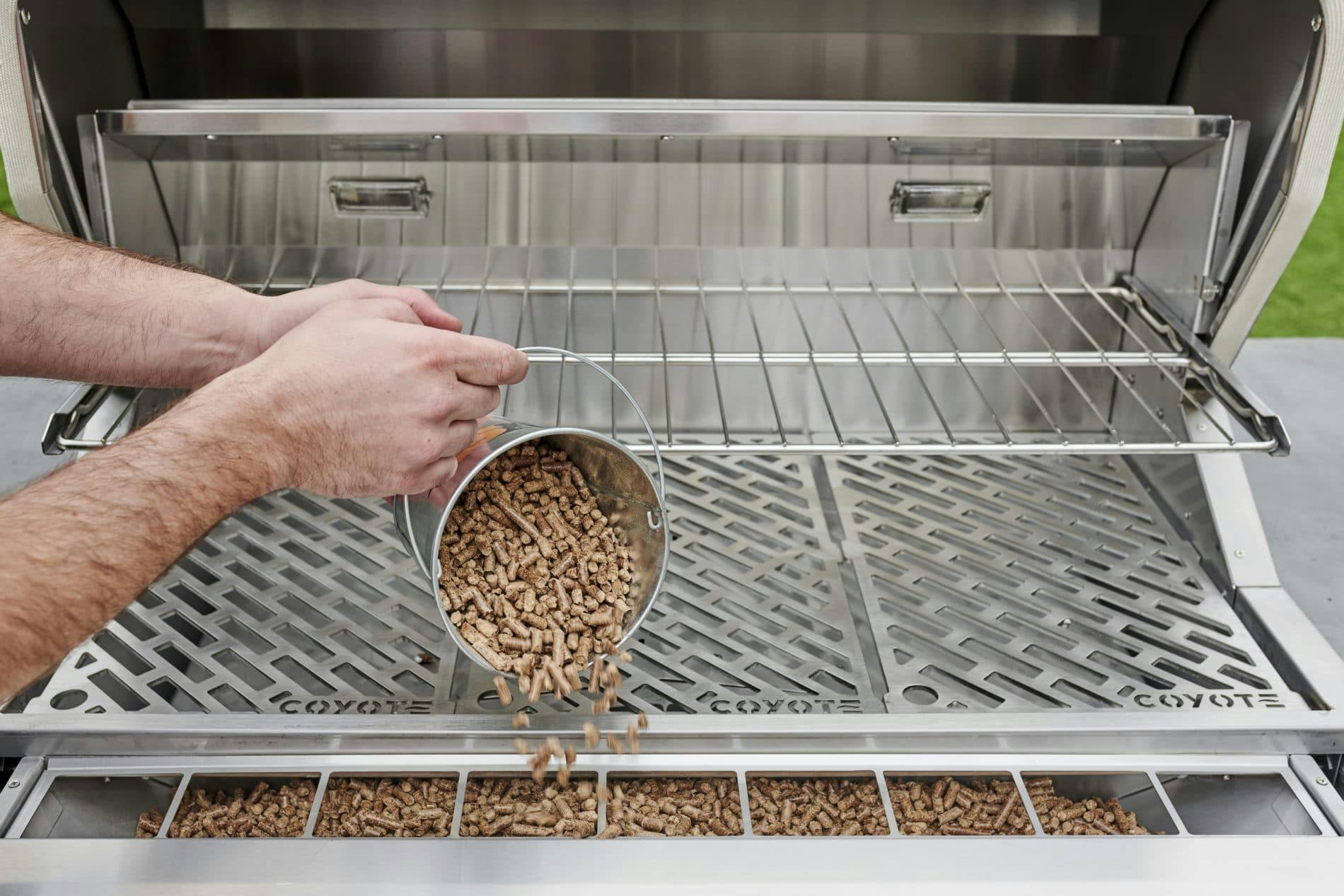 pouring pellets in coyote grill