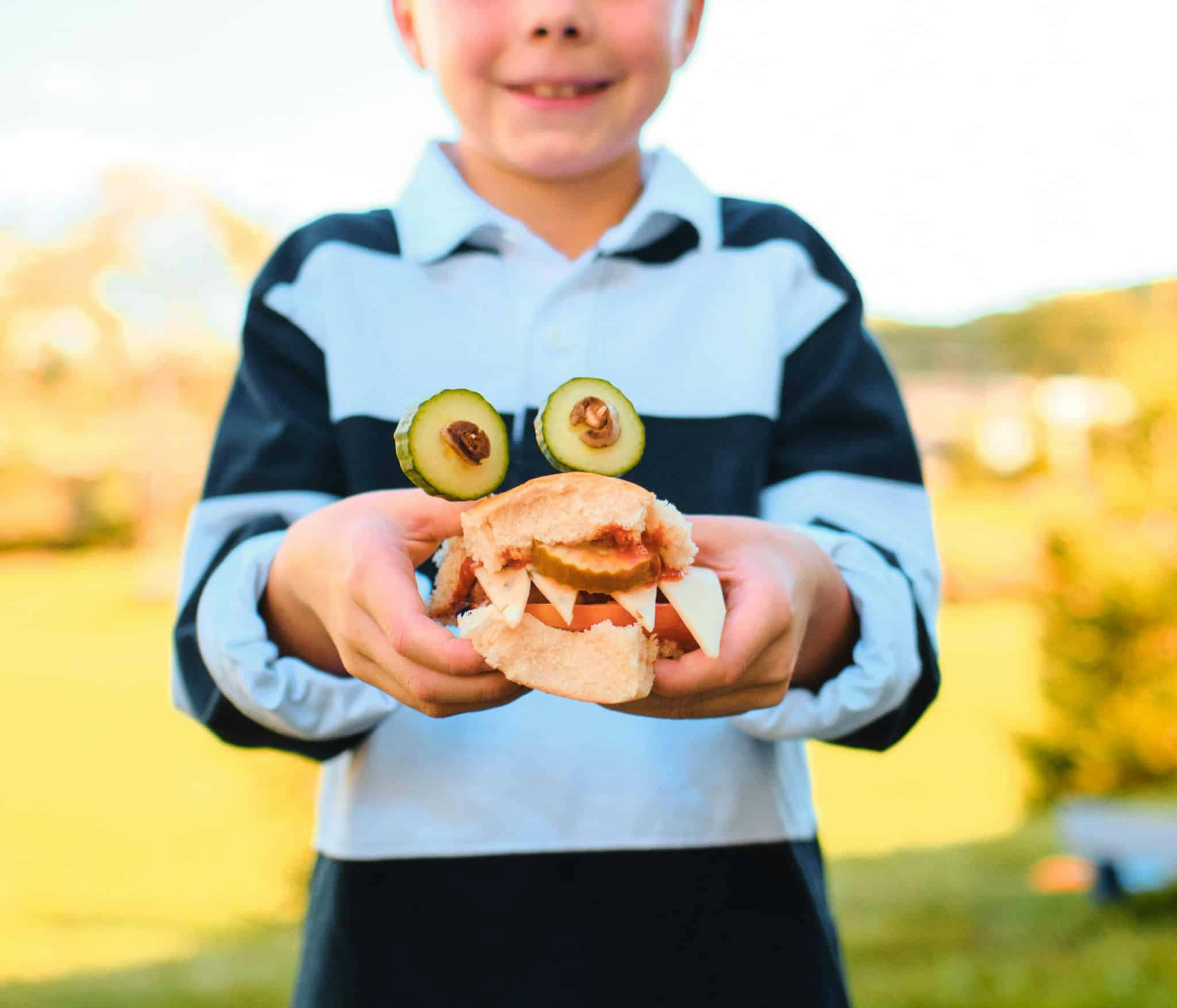 kid holding sandwich slider