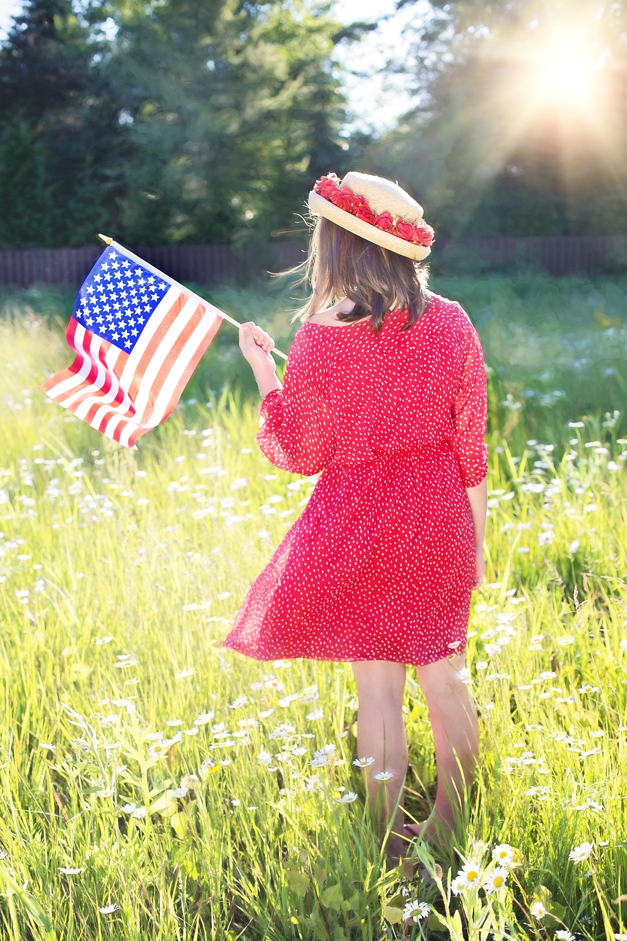 Girl holding American flag.