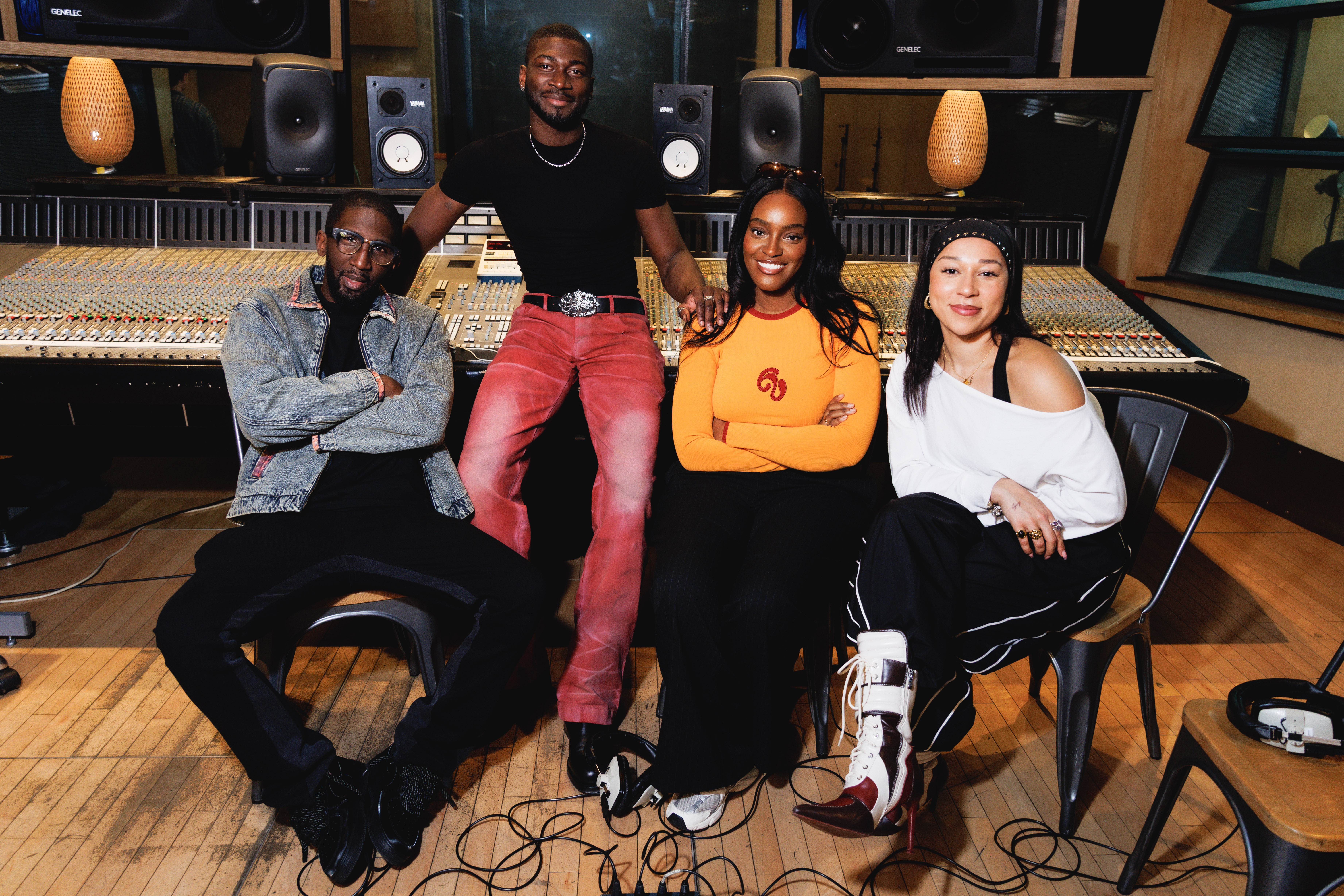 Ayamé, Sarel, Victor Kunda and Specs Gonzalez smiling in a studio.