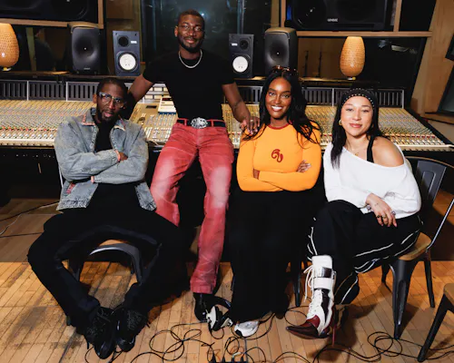 Ayamé, Sarel, Victor Kunda and Specs Gonzalez smiling in a studio.