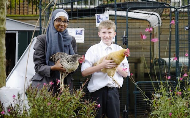 students holding chickens