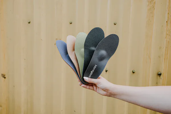 Frau hält craftsoles Einlagen gefächert in der Hand