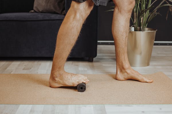 Mann macht Übung mit der Blackroll