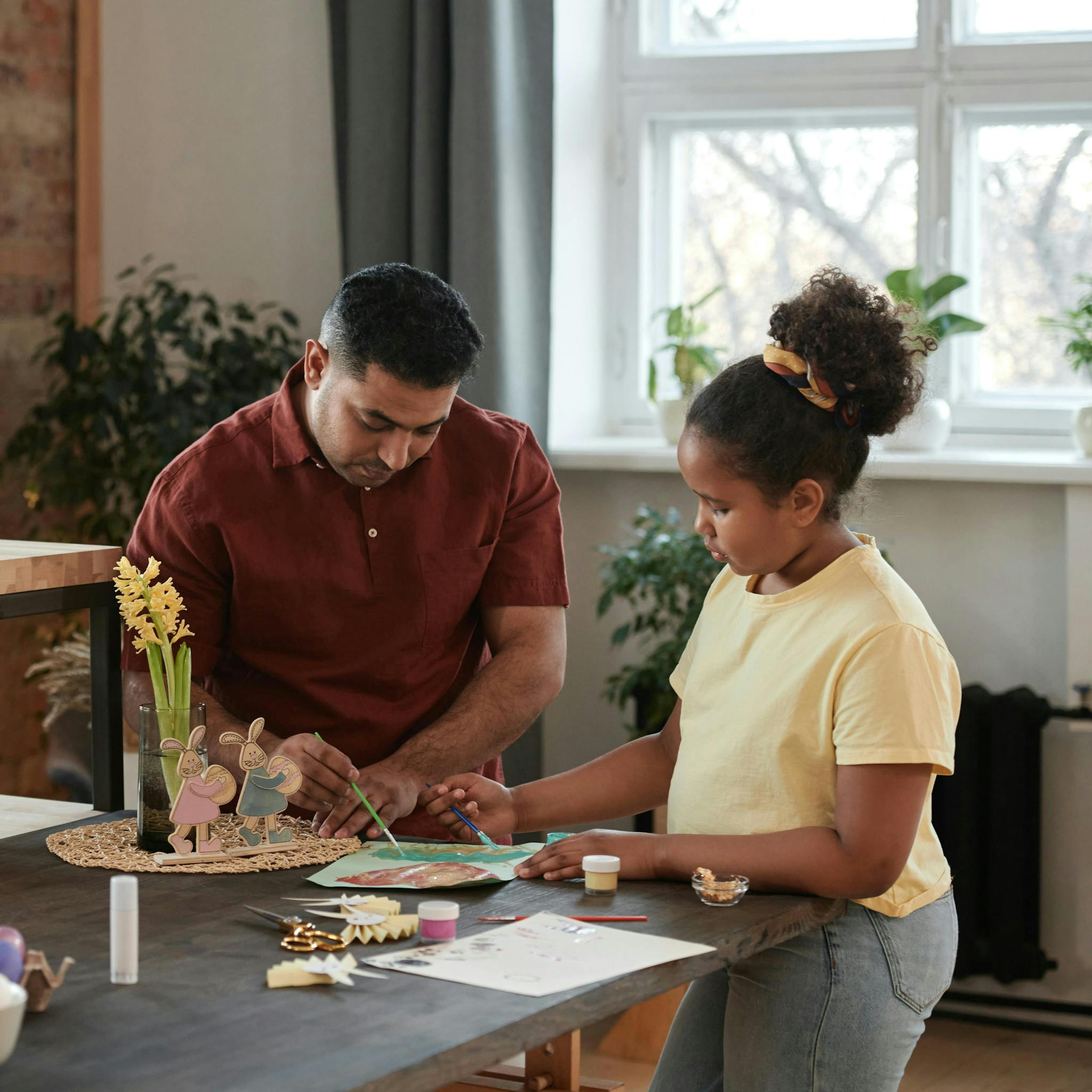 Father and daughters crafting together