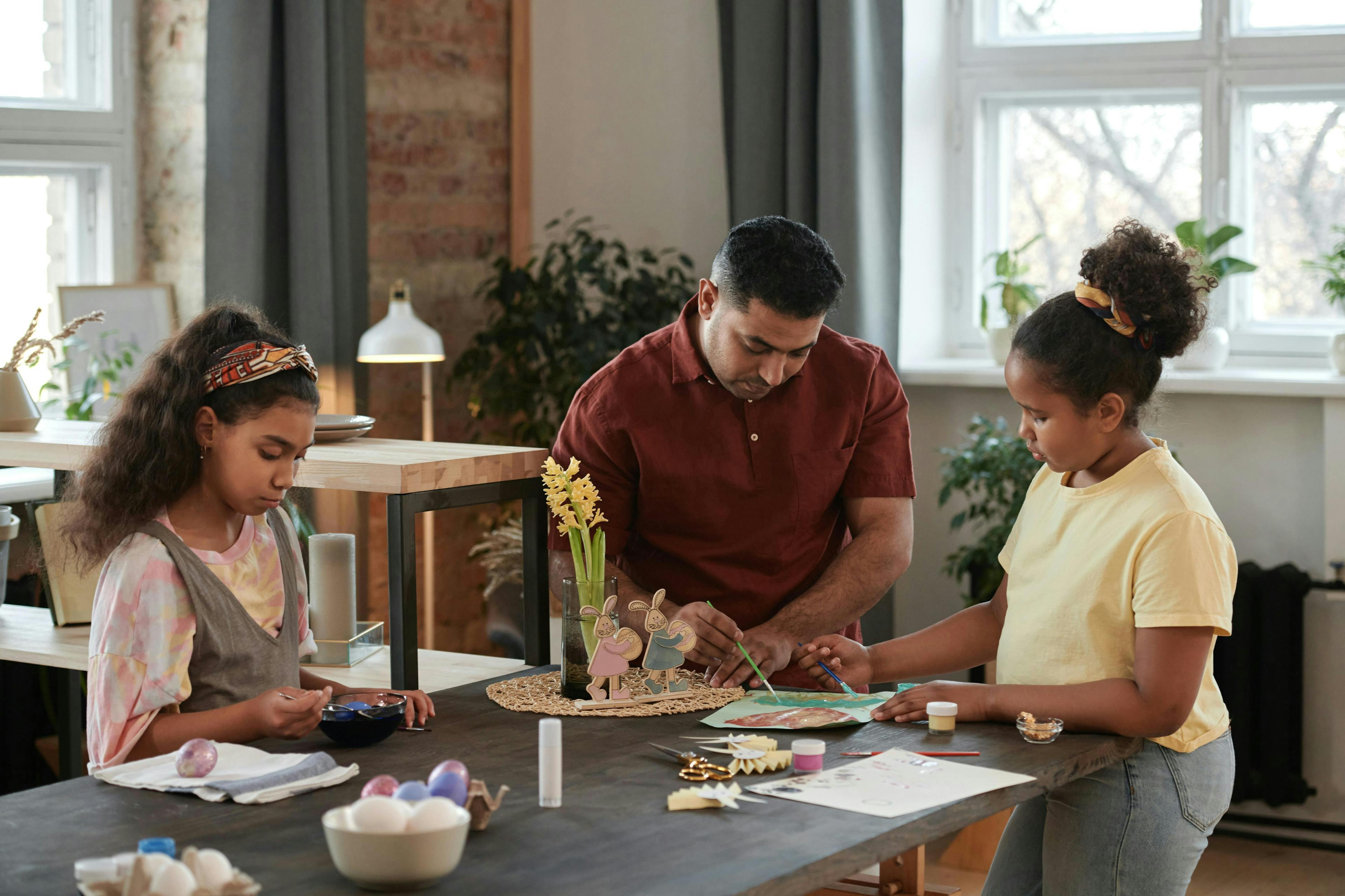 Father and daughters crafting together