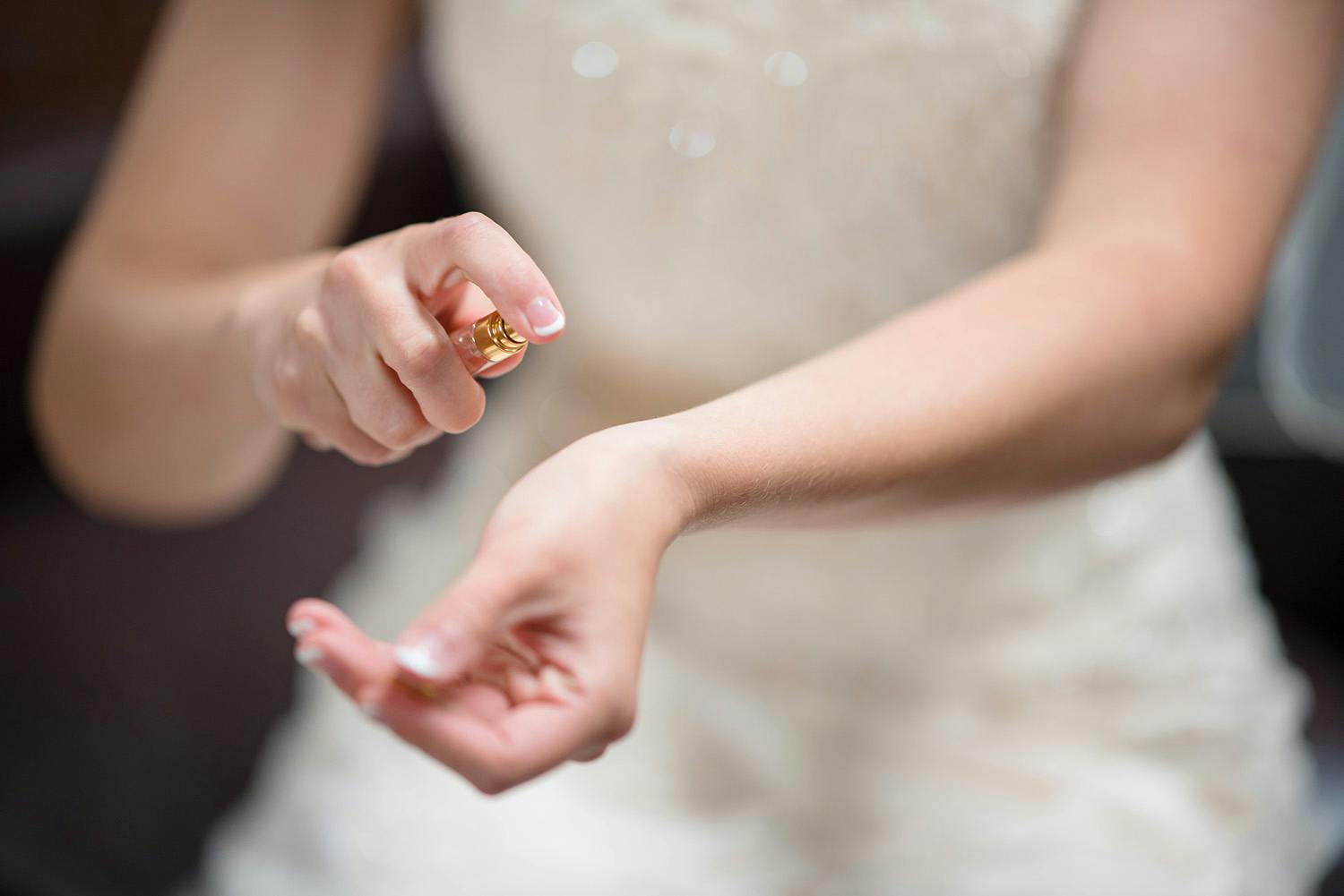 Woman spraying perfume on her wrist