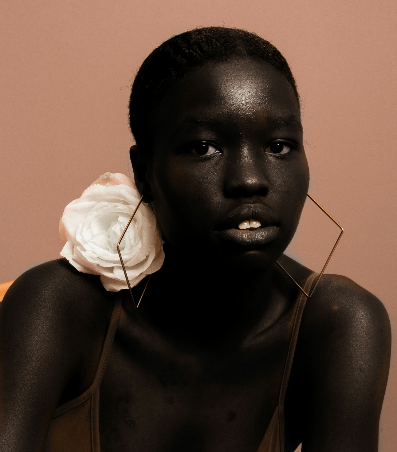 Lady with a white rose on a coral background