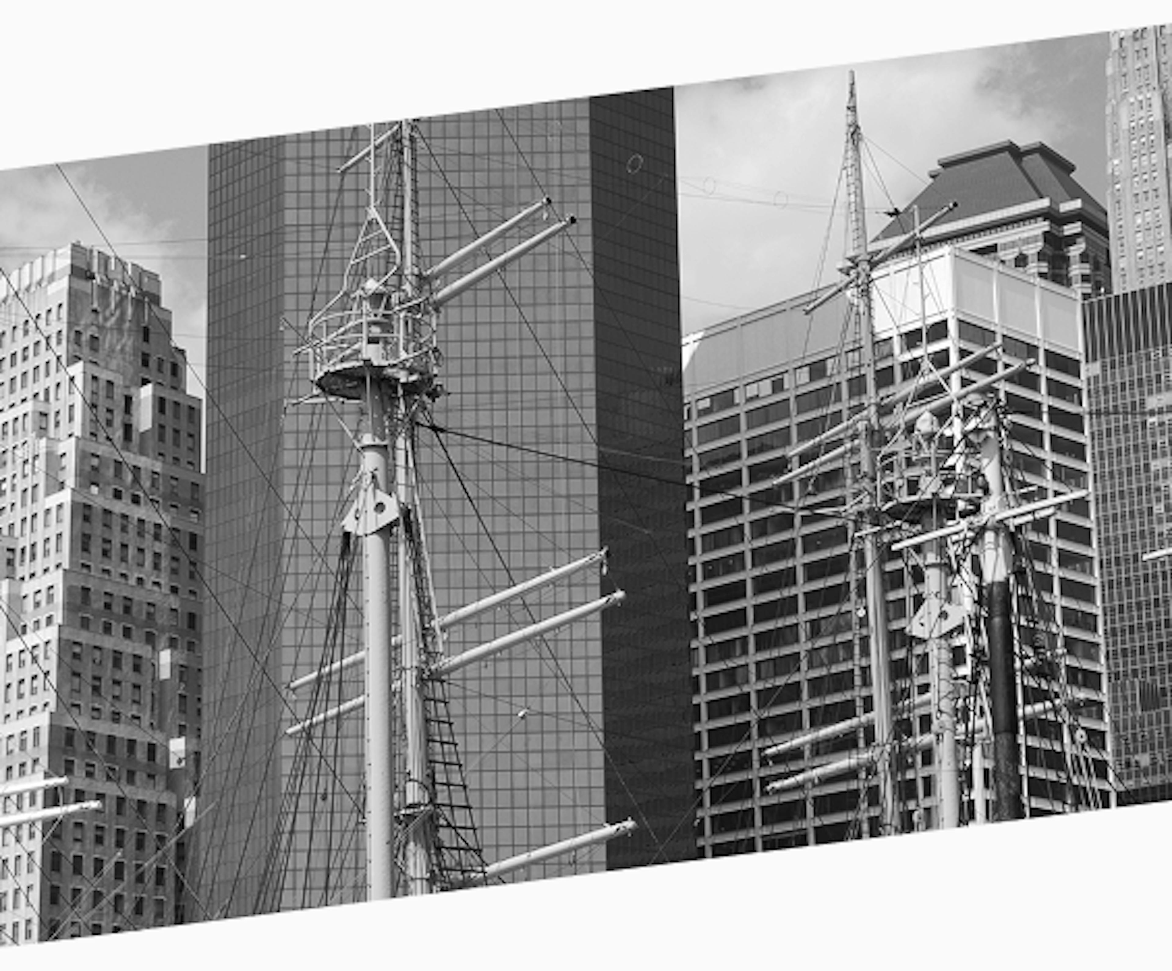 Tall sailing ship masts and rigging set against a backdrop of modern skyscrapers in Lower Manhattan, New York City.