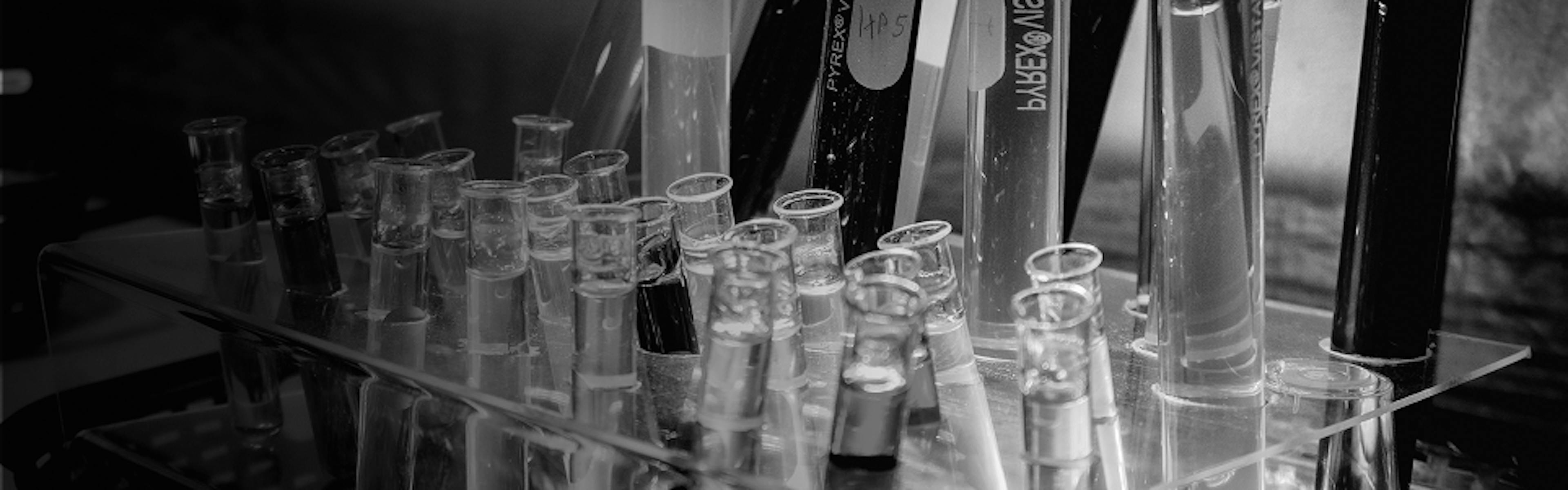 Scientific glassware with cannabis oil samples, illustrating terpene extraction and lab testing processes