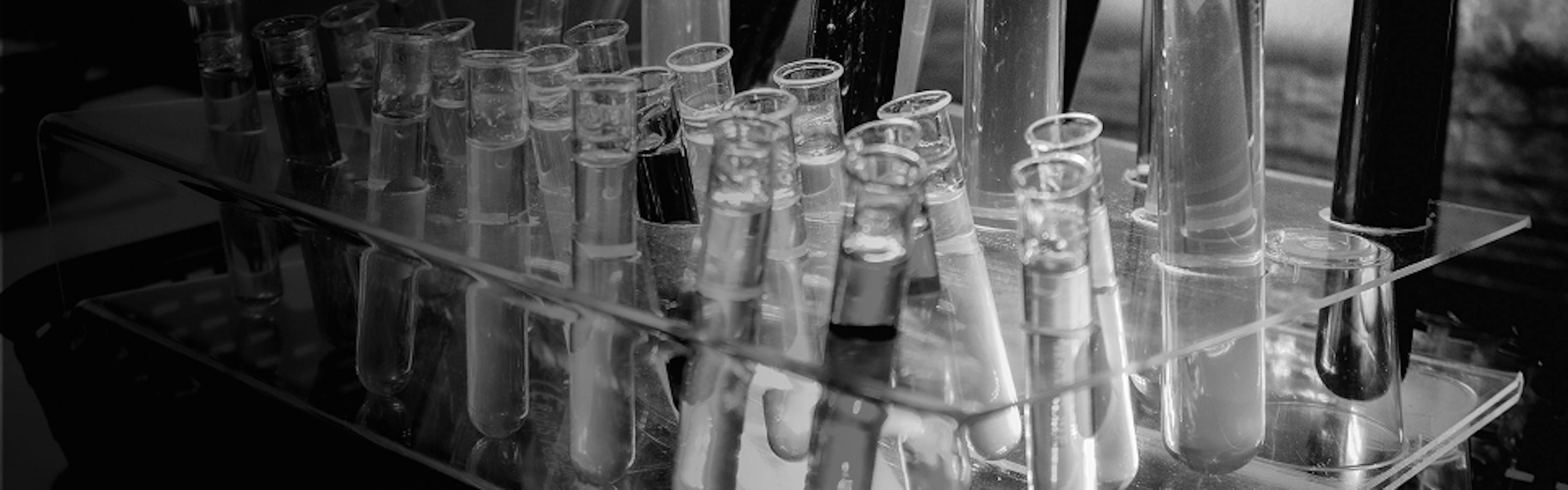 Scientific glassware with cannabis oil samples, illustrating terpene extraction and lab testing processes
