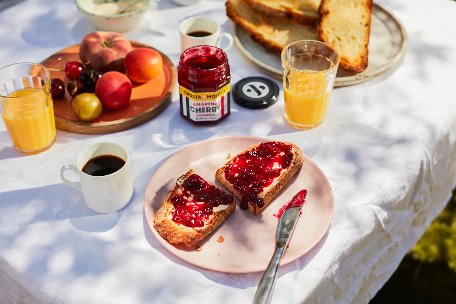 Cherry conserve spread on toast on an al fresco breakfast table | Crosta & Mollica