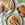 Shot from above, three plates are in view. One has folded Piadina on it, with a small pot of pickled red onions, while another has an assembled lime and chilli chicken piadina. The third plate has sliced chicken breast on it, wedges of lime are scattered between the plates.