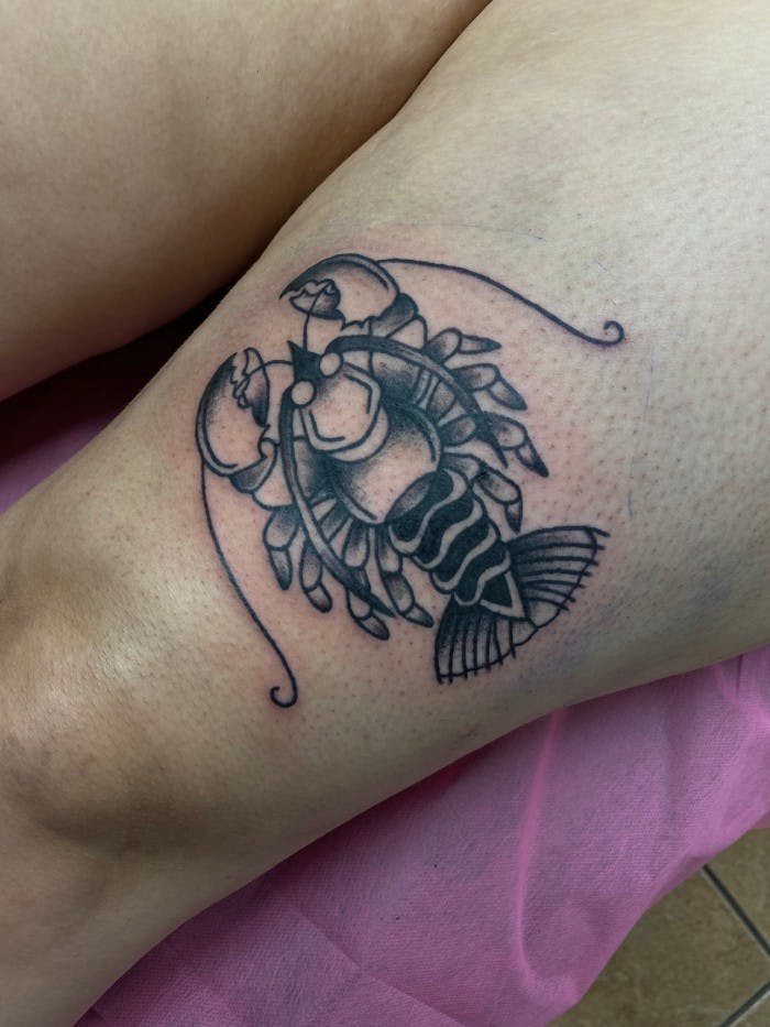 Tattoo of a beady-eyed lobster.