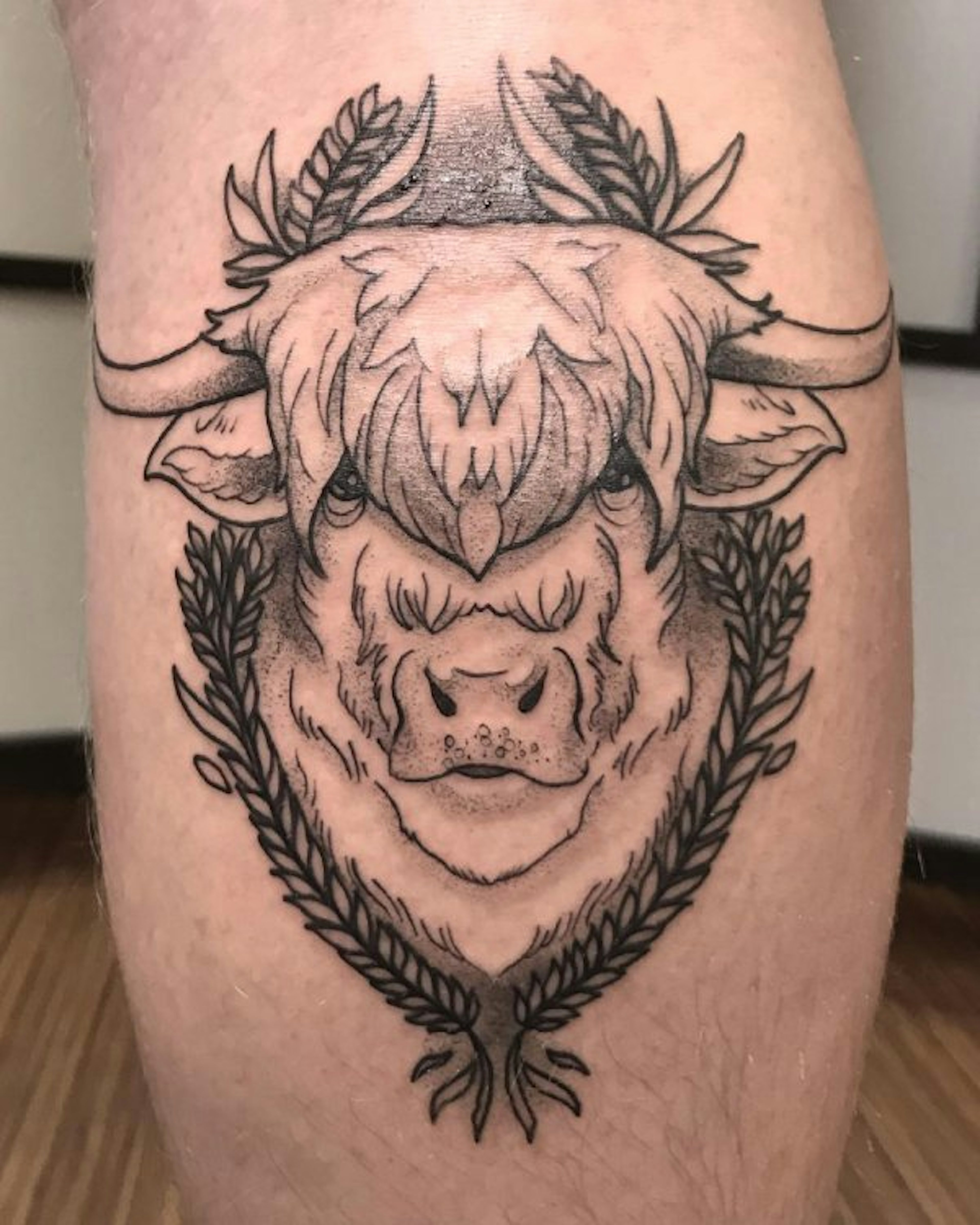Tattoo of a fluffy bison face created by Ilya.