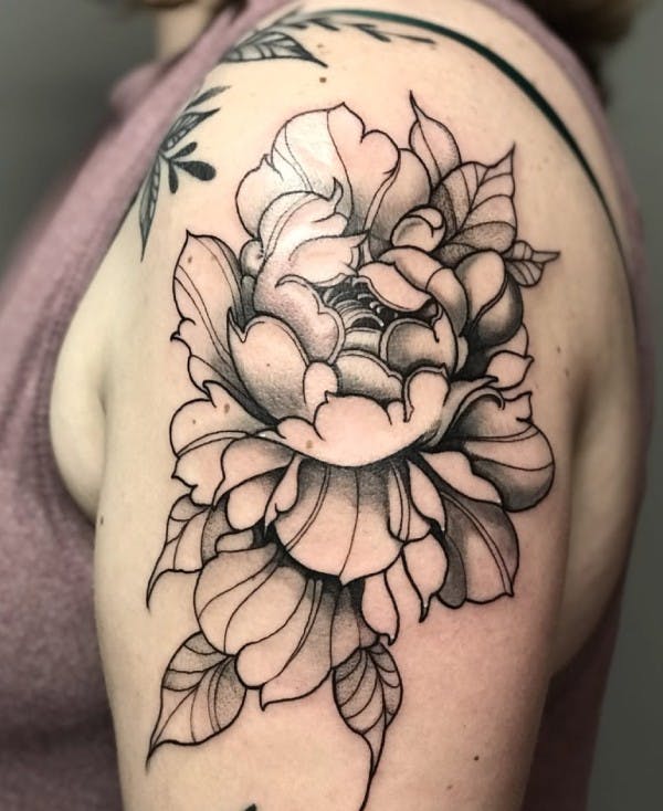 Tattoo of a flower on an arm.