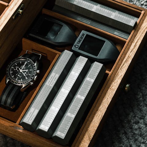 Jewellery drawer with an Omega watch, titanium Cryptotag Odin hexagons, and Trezor Model T crypto hardware wallets