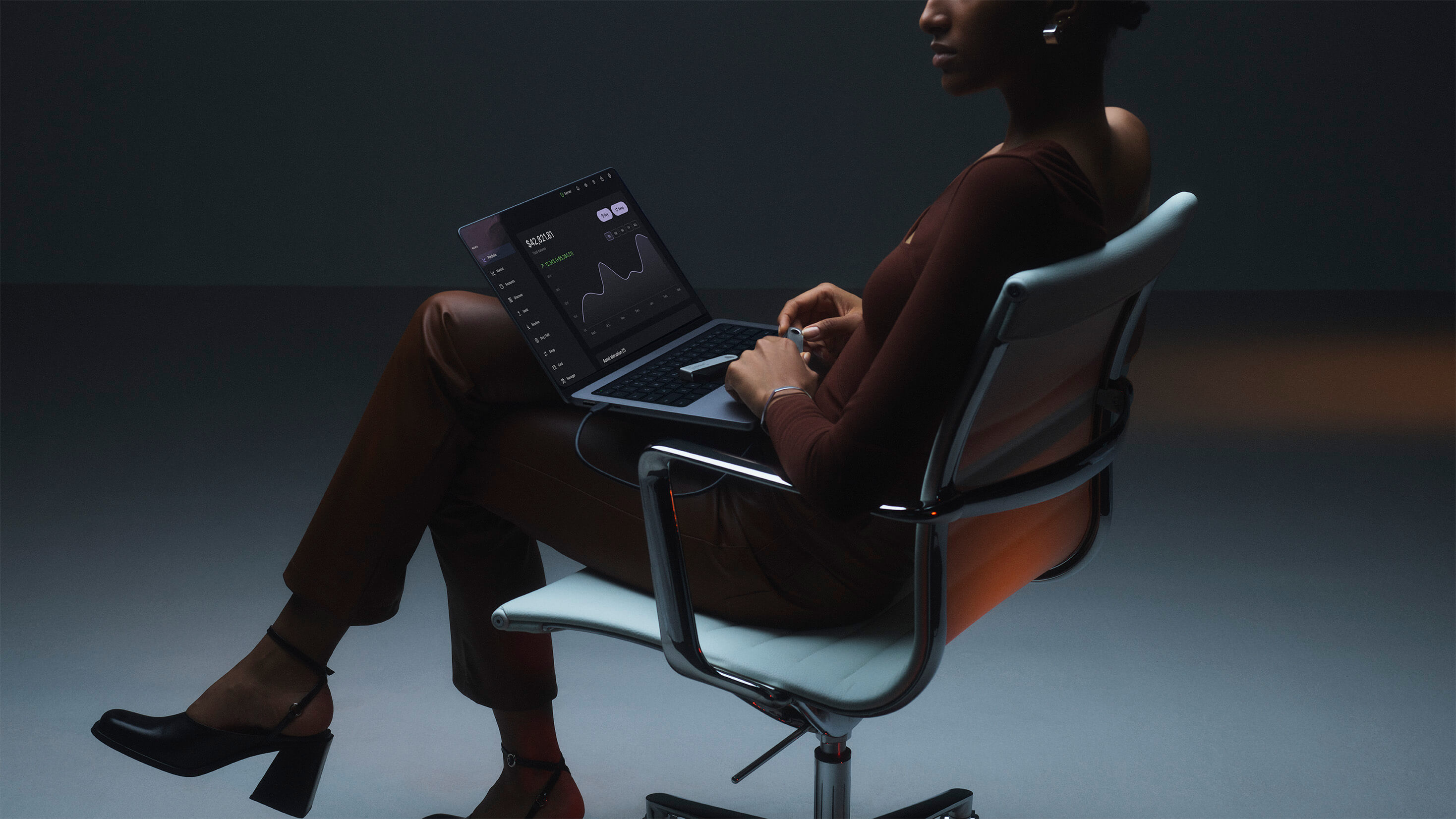 Ledger wallet laying on a Macbook that displays the Ledger Live app