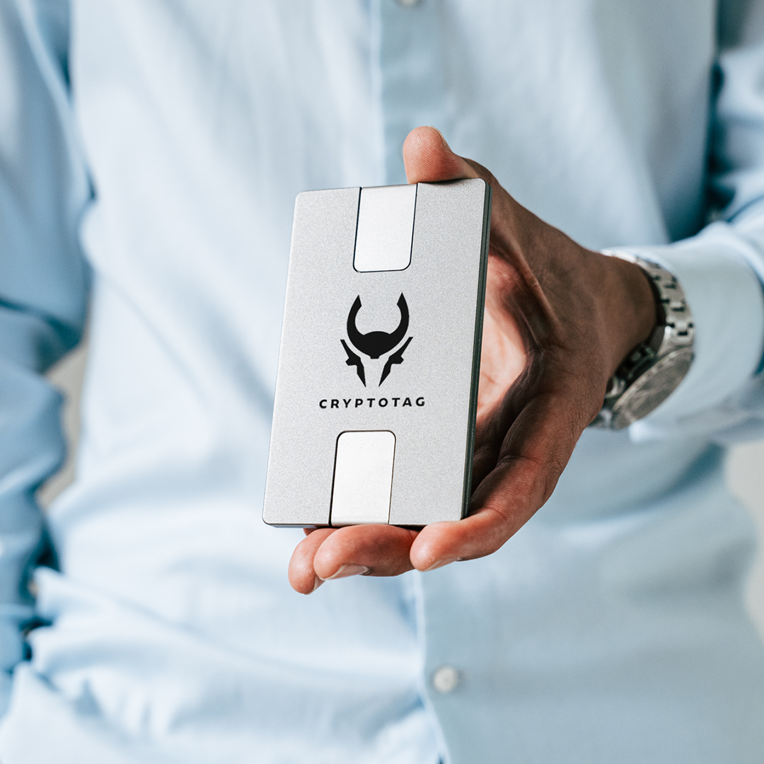 A hand holding a Cryptotag Zeus