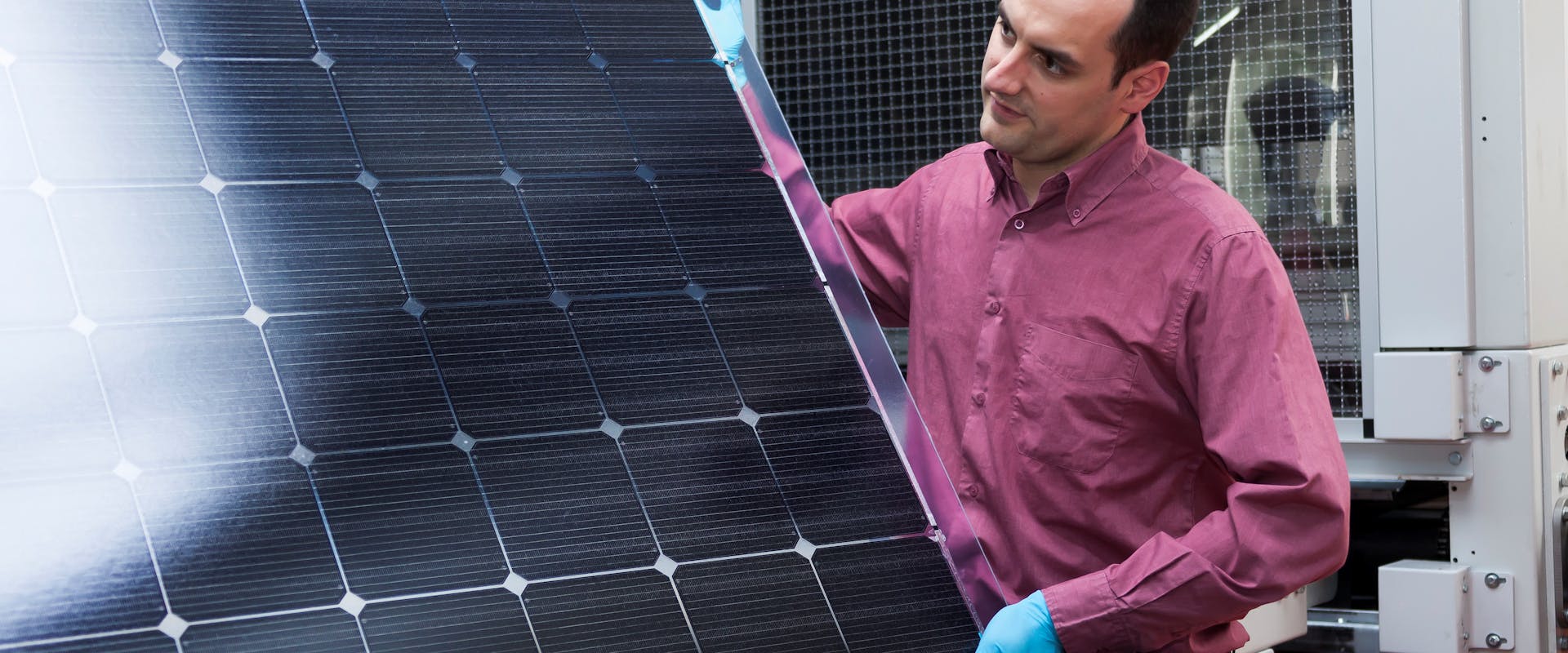 A CSEM colleague displays a Meyer Burger Heterojunction/SmartWire solar panel, which contains CSEM's technology