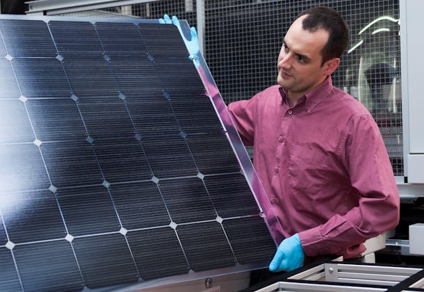 A CSEM colleague displays a Meyer Burger Heterojunction/SmartWire solar panel, which contains CSEM's technology