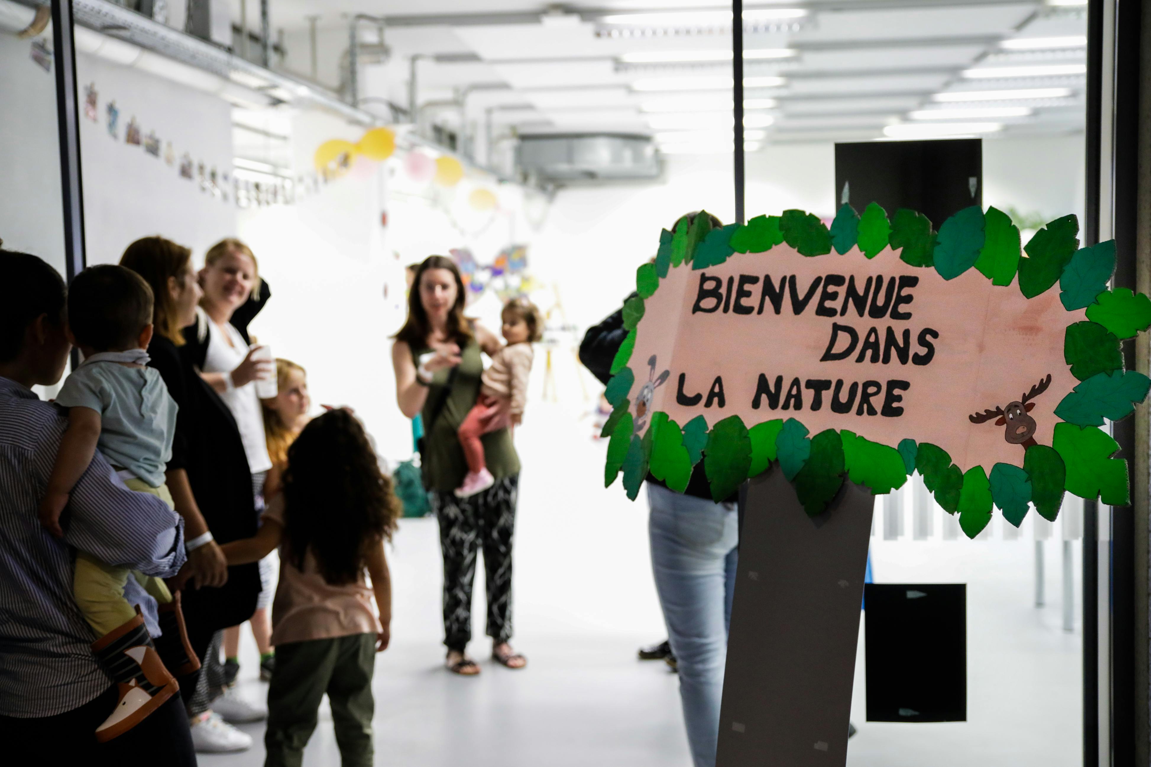 A group of people stood in a room in front of a welcome sign