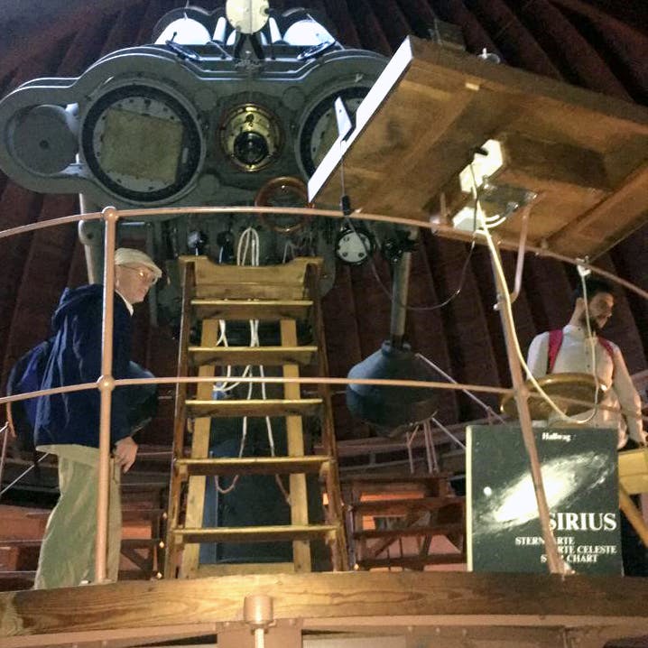 ESLW 2022 lab tour: Prof. Dr. Wolfgang Elsäßer inspecting the triple-refractor Carl Zeiss of Jena telescope in service since 1911.