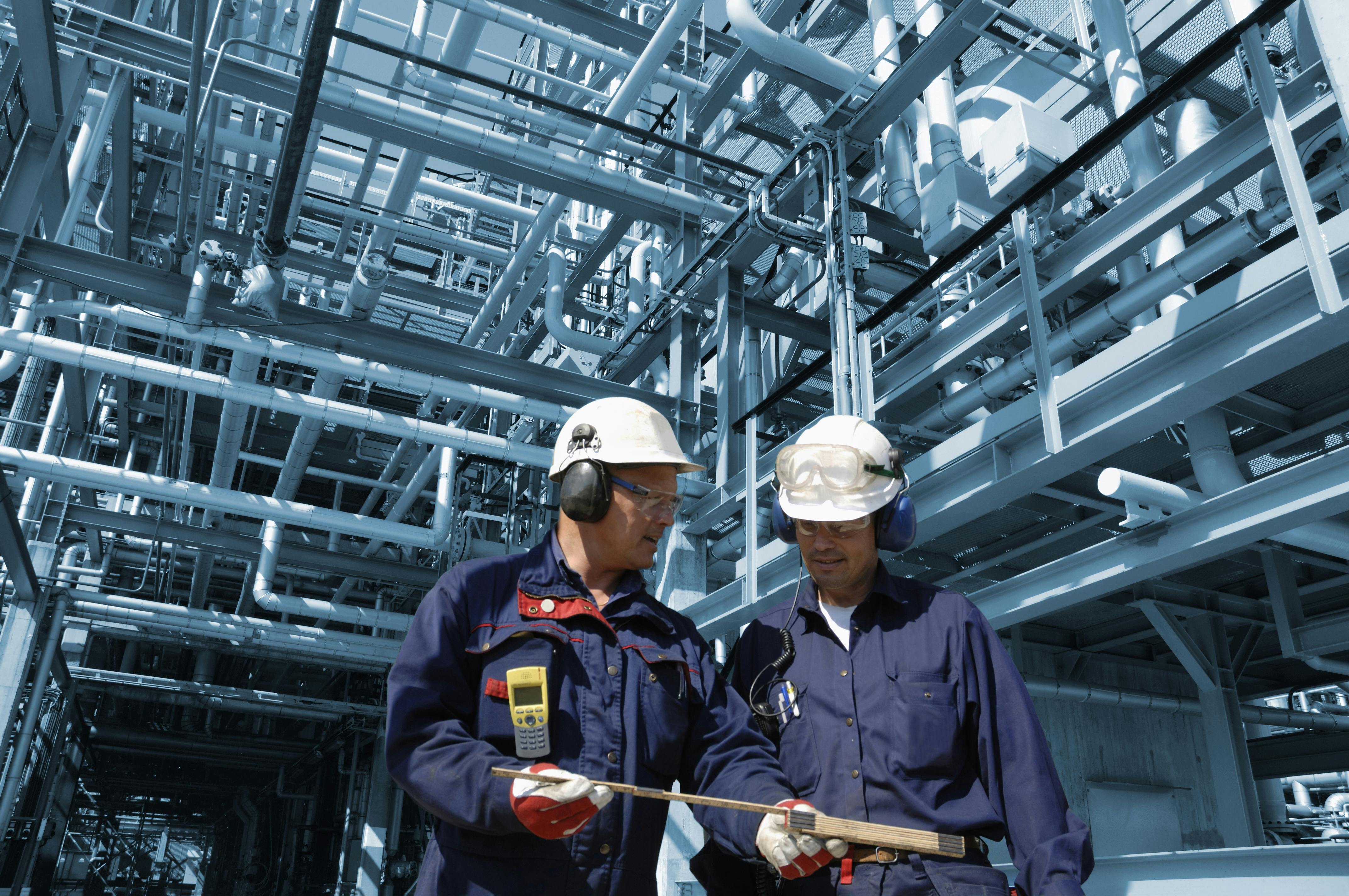 Two male engineers working on a petrol platform