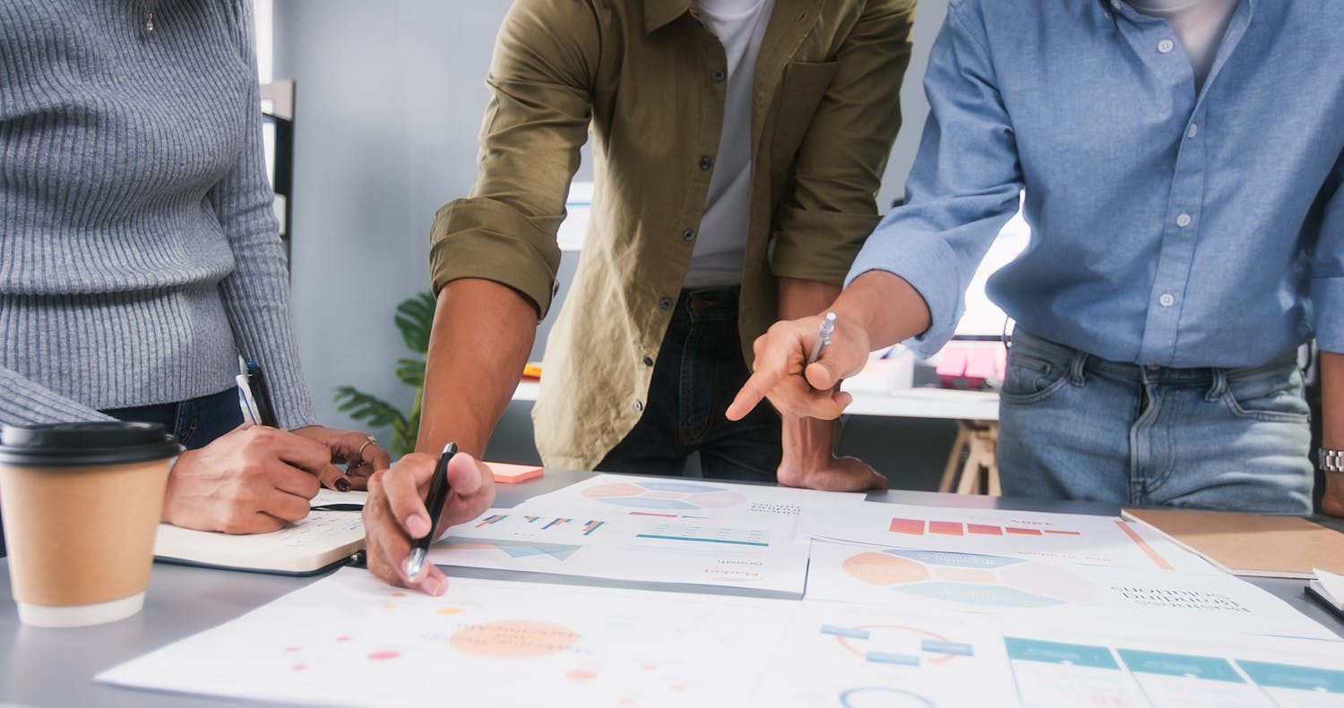 Three people working on a business project