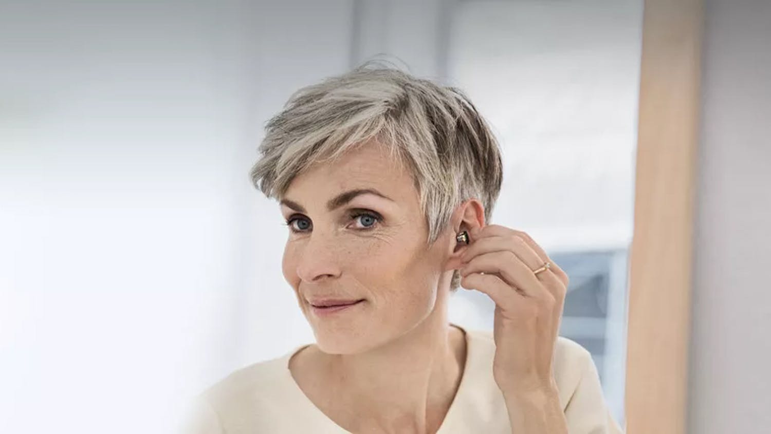 A woman wearing an Oticon hearing aid