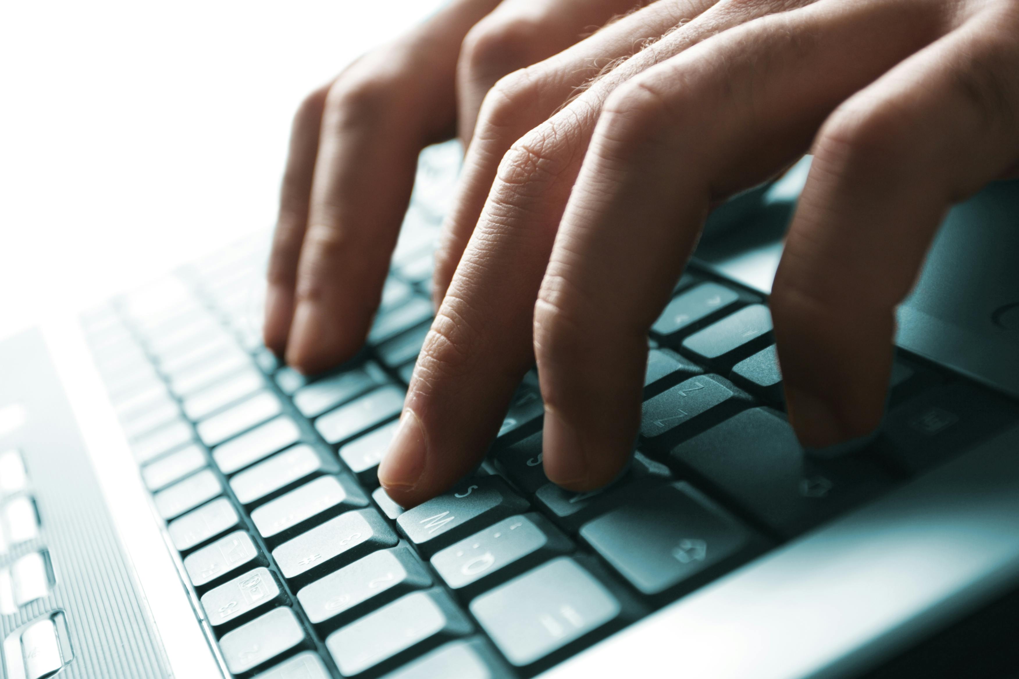 Man typing on a keyboard
