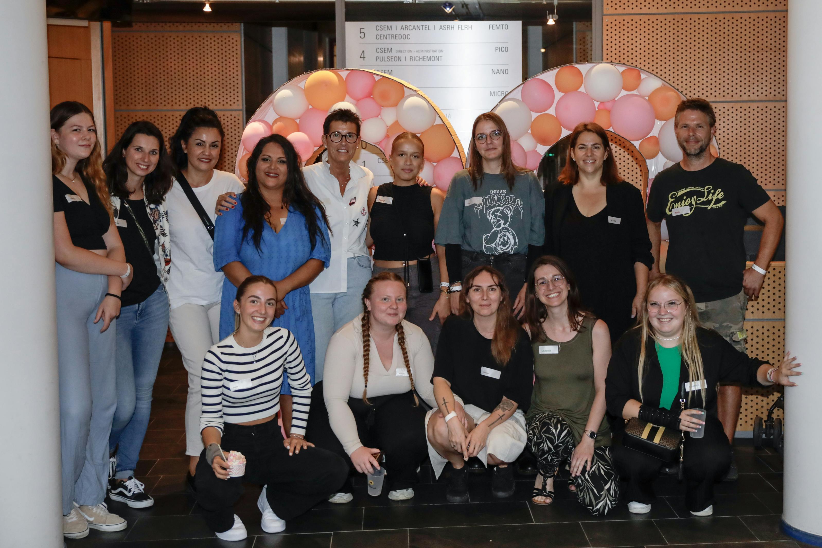 Early childhood educators standing in front of a large 20 number made of balloons