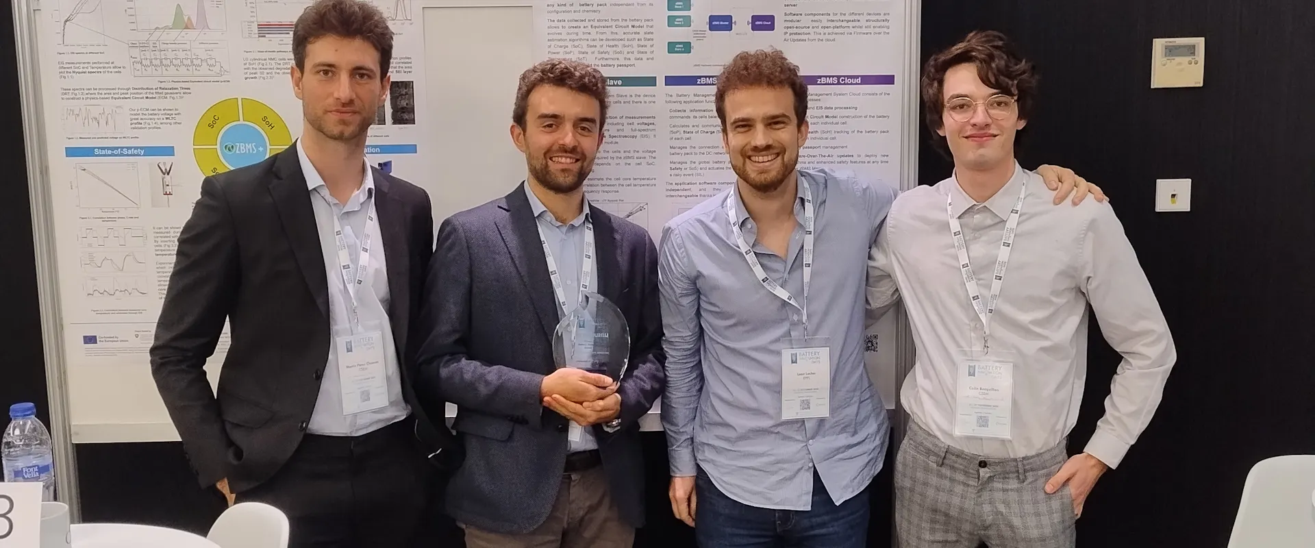 Martin Perez Chuecos, Battery BMS Software Architect & Developer; Pietro Iurilli; Leon Locher, BIH collaborator; and Colin Bocquillon, Battery BMS Hardware Developer, standing in front of a scientific poster.