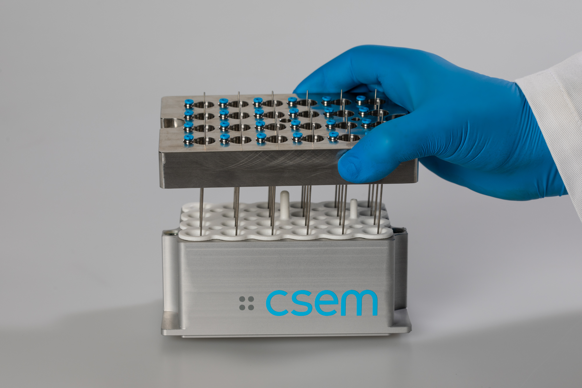 Hand holding a 24-channel labware