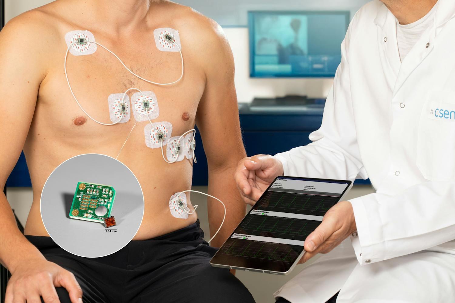 Man with sensors fixed to his chest sitting next to a doctor holding a tablet.