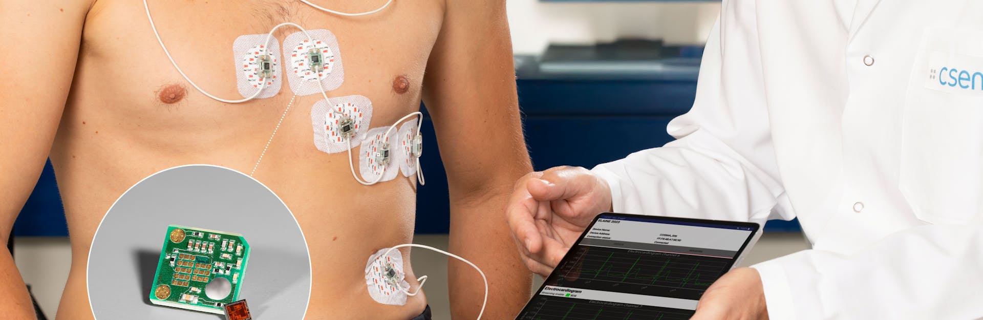 Man with sensors fixed to his chest sitting next to a doctor holding a tablet.