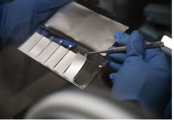 A CSEM expert carefully unloads thin-film Li-metal anodes, deposited via thermal evaporation, onto a Cu current collector.