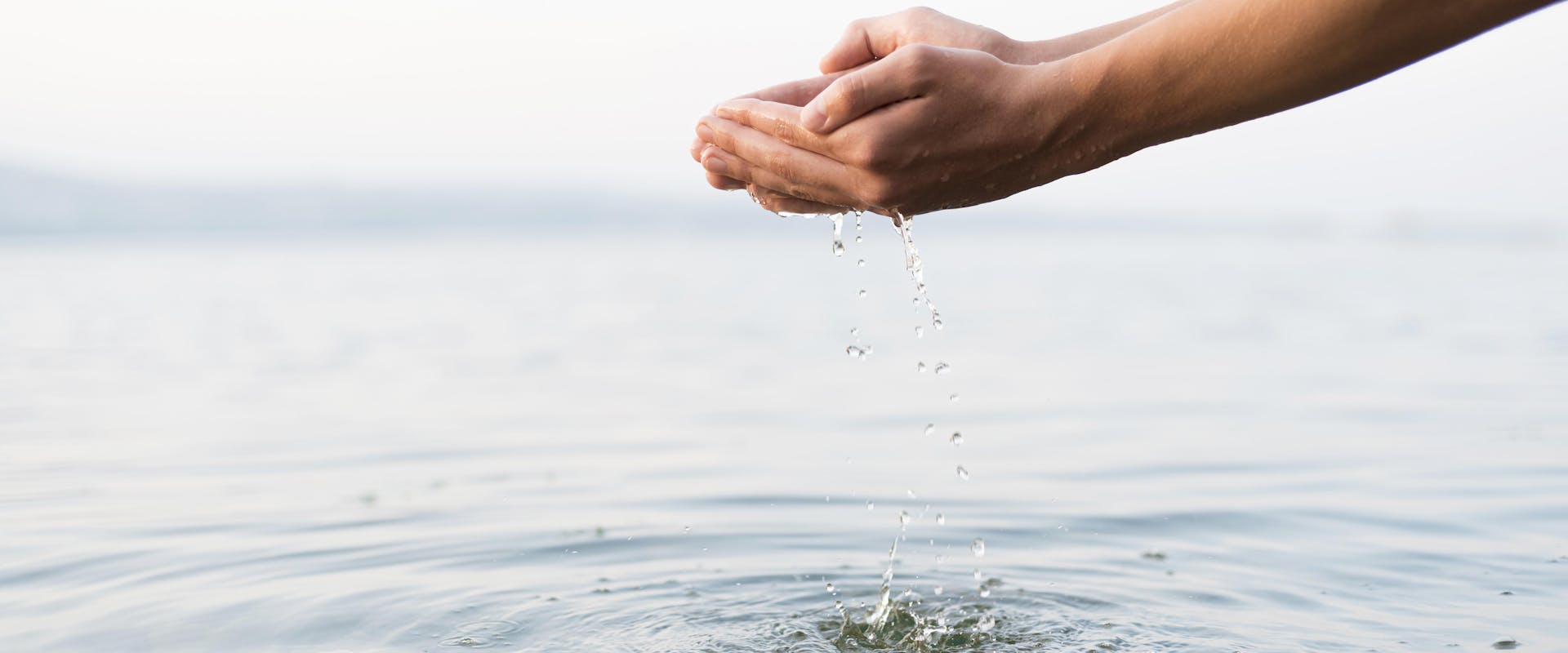 Close up of a hand cupping water