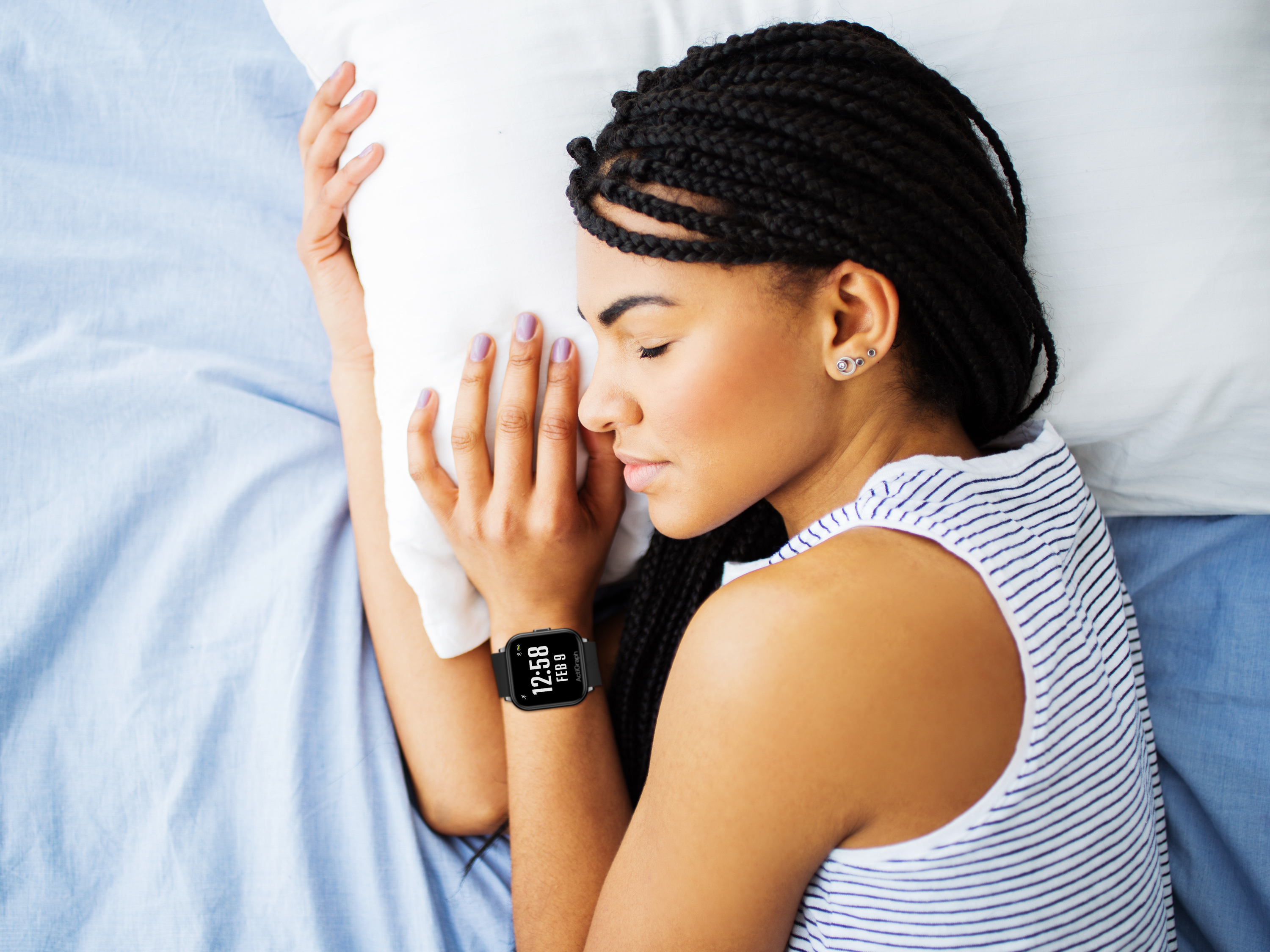 A sleeping woman wearing the ActiGraph LEAP™ 