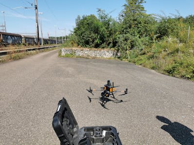 View on a drone on the ground, next to railway tracks and bushes of plants