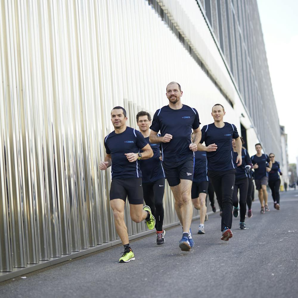 Groupe of employees running in town